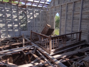 Looking inside wooden church ruins. Almost looks staged the way the altar leans just so.