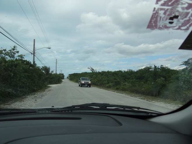 Driving on the left side of the road.