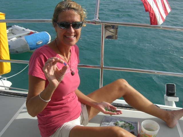 Sea glass sorting and showing off a small piece of blue