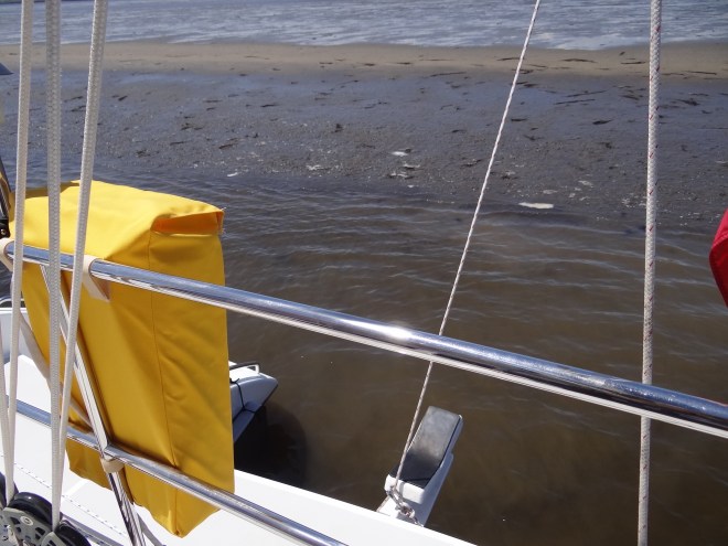 Way too close; the rudders are nudged into the mud