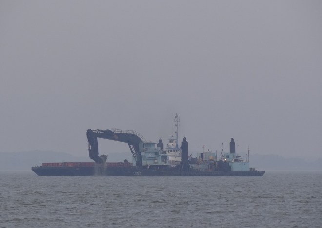 This dredge just scoops. Water is apprx 30ft there- "sand waves" according to our charts