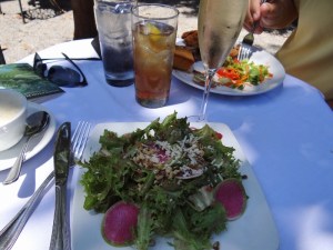 A delicious salad of greens, watermelon radish slices, walnuts and more.