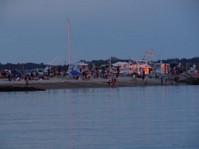 Sunset watchers on the beach wait expectantly