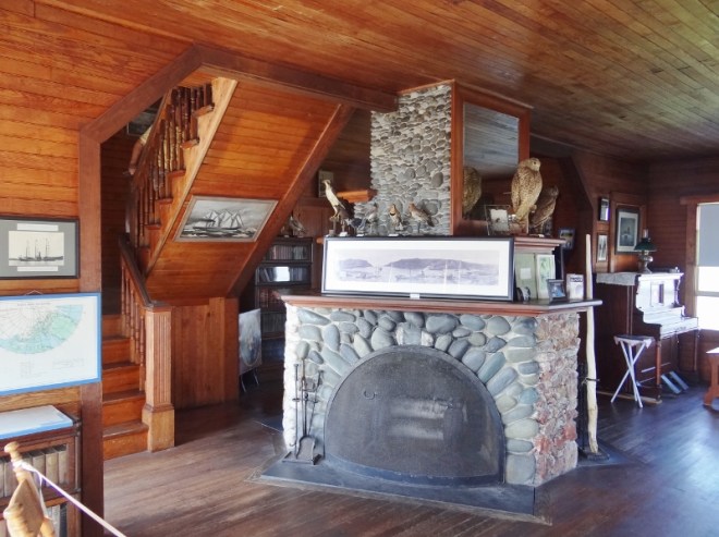 The great room with 3-sided fireplace and a player piano