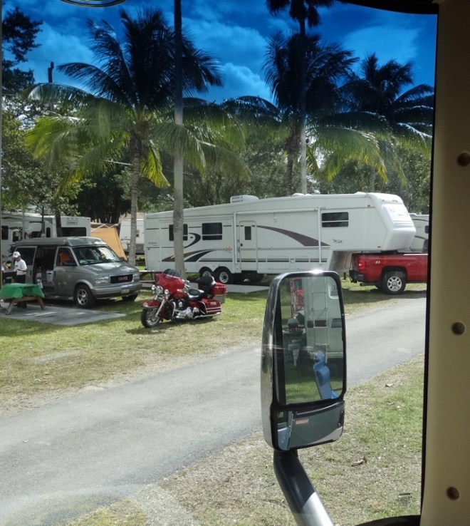 Across the road a fifth wheel backs in next to the tiny camper