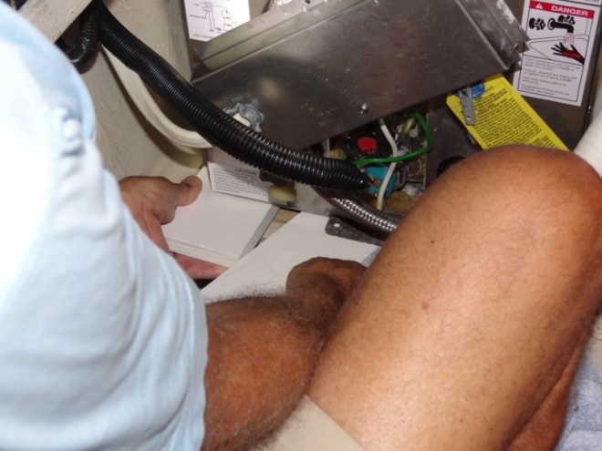 plastic boards that Russ cut at Home Depot under the hot water htr