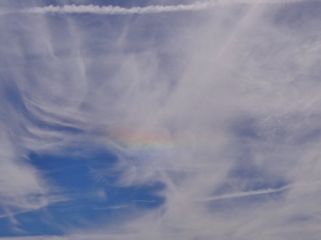 Rainbow bar in clouds but no rain- called Fire Rainbow- ice crystals create color